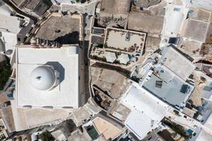 Orthodox Church with its multitiered bell tower facade in Emporio, Santorini, Greece. photo