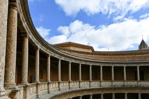 Granada, Spain - Nov 29, 2021, The unique circular patio of the Palace of Charles V  Palacio de Carlos V  with its two levels of columns of Doric and Ionic colonnades, Alhambra, Granada, Spain. photo