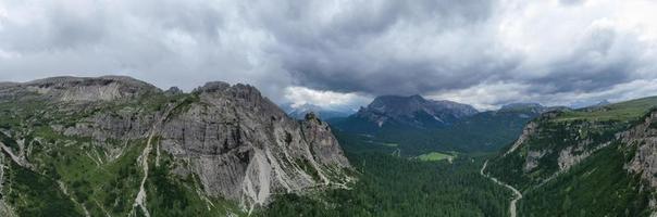 Mountain landscape surrounding Tre Cime park in Italy on a foggy, cloudy, summer, day. photo