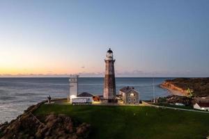 Montauk Lighthouse and beach at sunrise, Long Island, New York, USA. photo