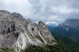 Mountain landscape surrounding Tre Cime park in Italy on a foggy, cloudy, summer, day. photo