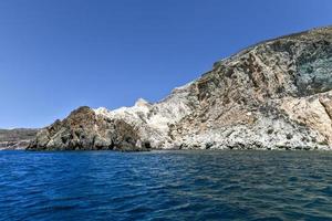 Santorini White Beach with a bright blue sky and the blue sea in Greece. photo