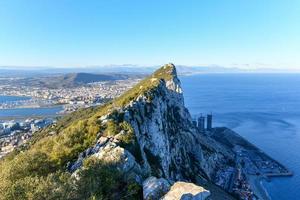 Aerial view of top of Gibraltar Rock, in Upper Rock Natural Reserve, on the left Gibraltar town and bay, Mediterranean Sea on the right, United Kingdom, Europe photo
