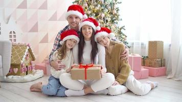 Happy young family with kids holding christmas presents video
