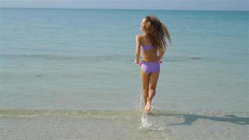 Cute little girl at beach during caribbean vacation video