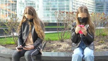 filles portant un masque sur fond d'un bâtiment moderne, video