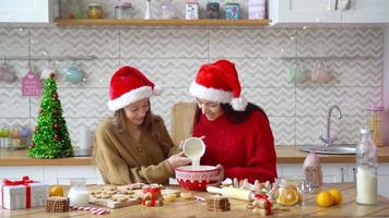 Happy family mother and daughter bake cookies for Christmas video