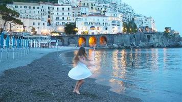 förtjusande liten flicka på solnedgång i amalfi stad i Italien video