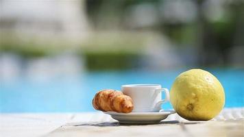 Delicious breakfast lemon, coffee, croissant by the pool video
