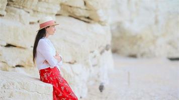 Young beautiful woman on white tropical beach. video