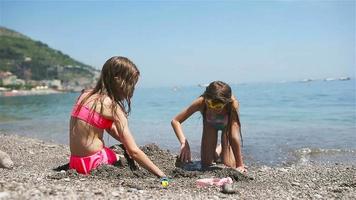 schattig weinig meisjes Bij strand gedurende zomer vakantie video