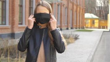 Girl wearing a mask protect against Coronavirus and gripp video