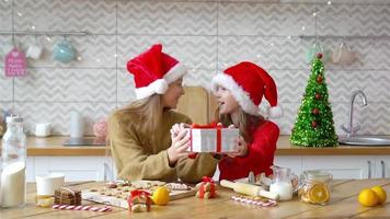 Little girls with gift on Christmas in decorated living room. video