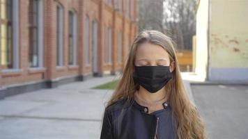 Girl wearing a mask protect against Coronavirus and gripp video