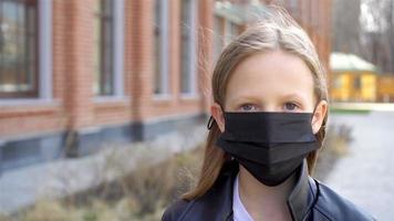 Girl wearing a mask protect against Coronavirus and gripp video