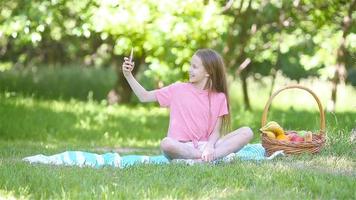 Little girl in yoga position in the park. video