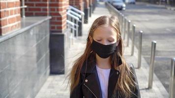 Girl wearing a mask protect against Coronavirus and gripp video
