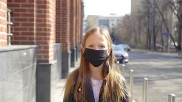 Girl wearing a mask protect against Coronavirus and gripp video