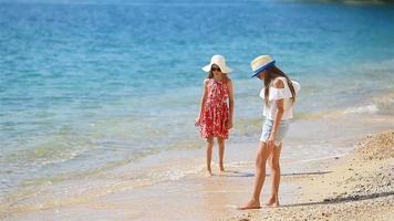 Little girls having fun at tropical beach during summer vacation video