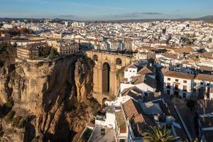 Rocky landscape of Ronda city with Puente Nuevo Bridge and buildings, Andalusia, Spain photo