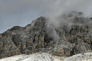 Mountain landscape surrounding Tre Cime park in Italy on a foggy, cloudy, summer, day. photo