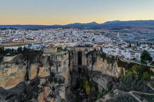Rocky landscape of Ronda city with Puente Nuevo Bridge and buildings, Andalusia, Spain photo