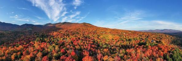 Panoramic view of peak fall foliage in Smugglers Notch, Vermont. photo
