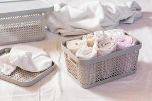 Neatly folded towels in a clothes drawer. Organization and order at home photo