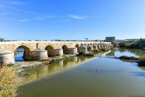 View of the Roman Bridge, a stone bridge that spans the river Guadalquivir in Cordoba, Spain. photo