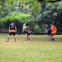 New Delhi, India, July 01 2018 - Footballers of local football team during game in regional Derby championship on a bad football pitch. Hot moment of football match on grass green field of the stadium photo