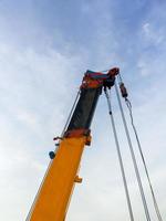 The long boom with the metal sling of the large mobile crane. photo
