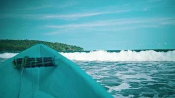 View of the big ocean waves from a fishing boat with a blue sky and beautiful sea video