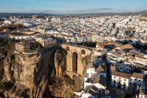 Rocky landscape of Ronda city with Puente Nuevo Bridge and buildings, Andalusia, Spain photo