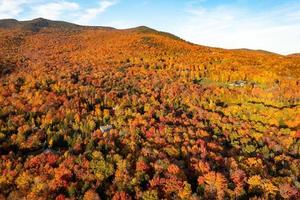 Panoramic view of peak fall foliage in Smugglers Notch, Vermont. photo