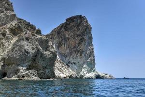 Santorini White Beach with a bright blue sky and the blue sea in Greece. photo