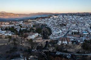 Rocky landscape of Ronda city with Puente Nuevo Bridge and buildings, Andalusia, Spain photo