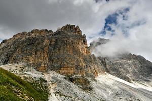 Mountain landscape surrounding Tre Cime park in Italy on a foggy, cloudy, summer, day. photo