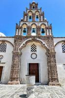 Orthodox Church with its multitiered bell tower facade in Emporio, Santorini, Greece. photo