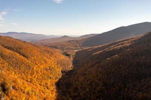 Panoramic view of peak fall foliage in Smugglers Notch, Vermont. photo