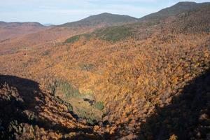 Panoramic view of peak fall foliage in Smugglers Notch, Vermont. photo