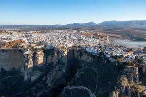 Rocky landscape of Ronda city with Puente Nuevo Bridge and buildings, Andalusia, Spain photo