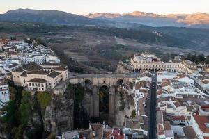 Rocky landscape of Ronda city with Puente Nuevo Bridge and buildings, Andalusia, Spain photo