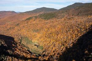 Panoramic view of peak fall foliage in Smugglers Notch, Vermont. photo