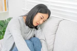 Depression and mental illness. Asian woman disappointed, sad after receiving bad news. Stressed girl confused with unhappy problems, arguing with boyfriend, cry and worry about unexpected pregnancy. photo