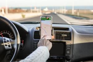 Crop driver using GPS navigator during road trip photo