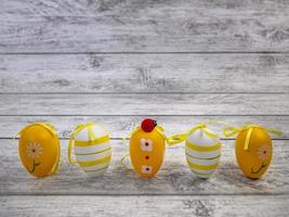 Easter eggs, ladybug on light wooden background and place to copy. greeting card for the celebration of Easter photo