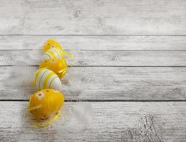 Easter eggs, feathers on a wooden background. Minimal concept. Easter card with a copy of the place for the text photo