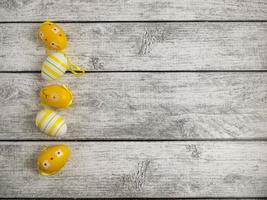 Easter eggs on a light wooden background and a copy space. A modern greeting card for the celebration of Easter photo