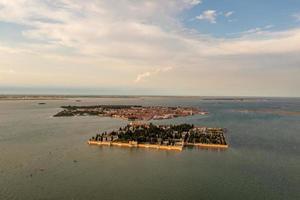 Aerial photo of historic Saint Michele cemetery island near Murano and Venice, Italy
