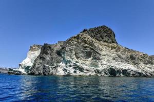 Santorini White Beach with a bright blue sky and the blue sea in Greece. photo